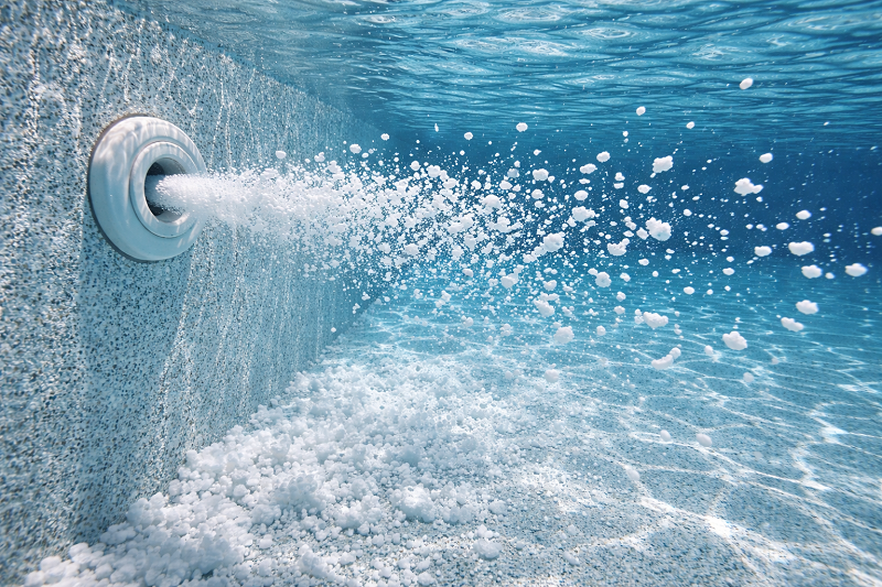 White Flakes from Return Jets in Salt Pools: Cell Scale or Plaster Dust?